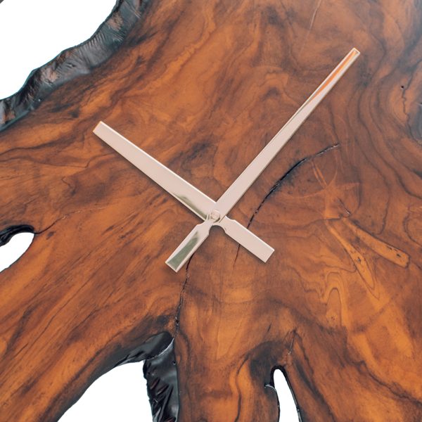 Detail of golden teak grain radiating from the center of the clock face
